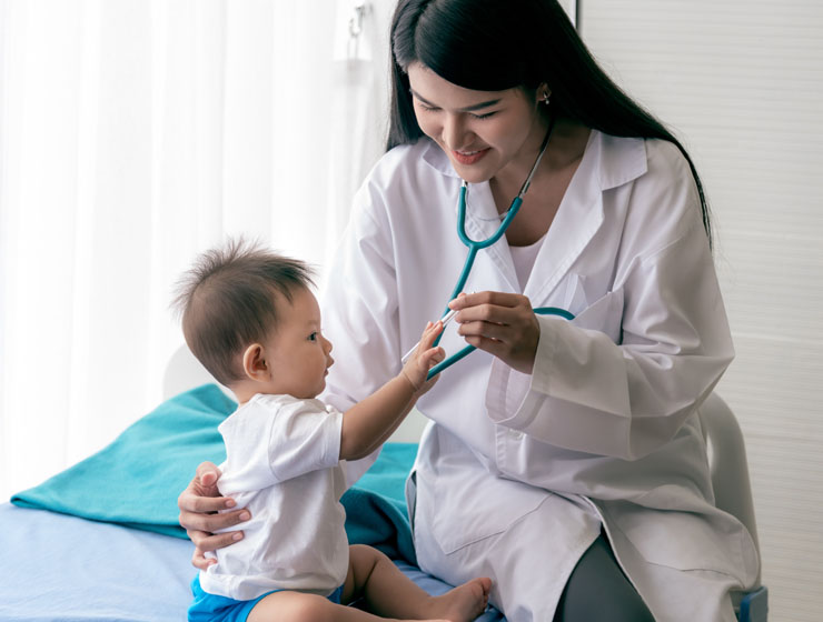 Baby playing  with doctors stethoscope. 