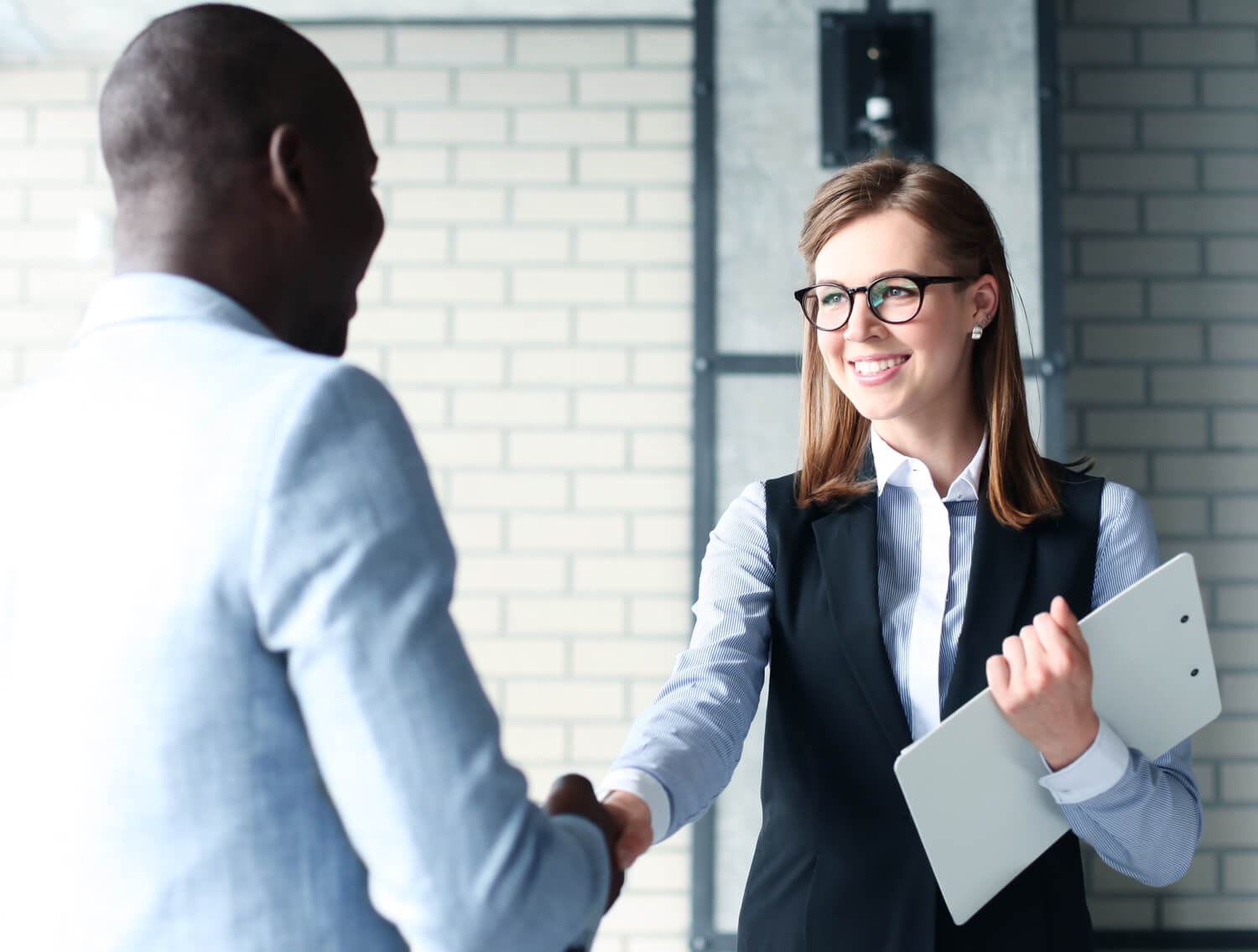 Sales manager shaking customers hand.
